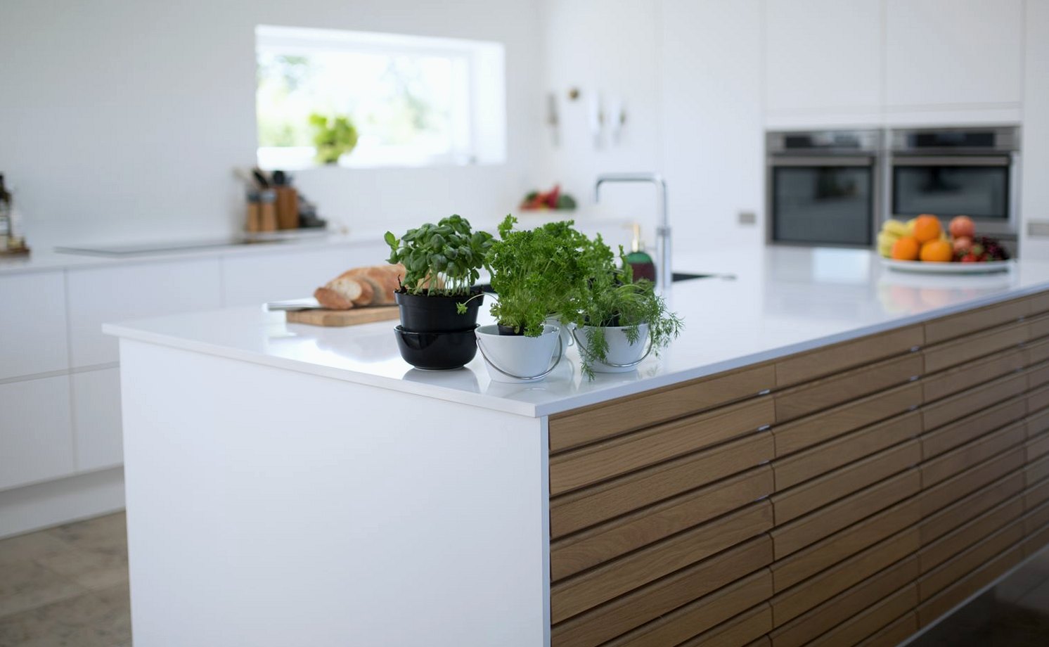 White kitchen worktop on a fitted island with oak-fronted drawers